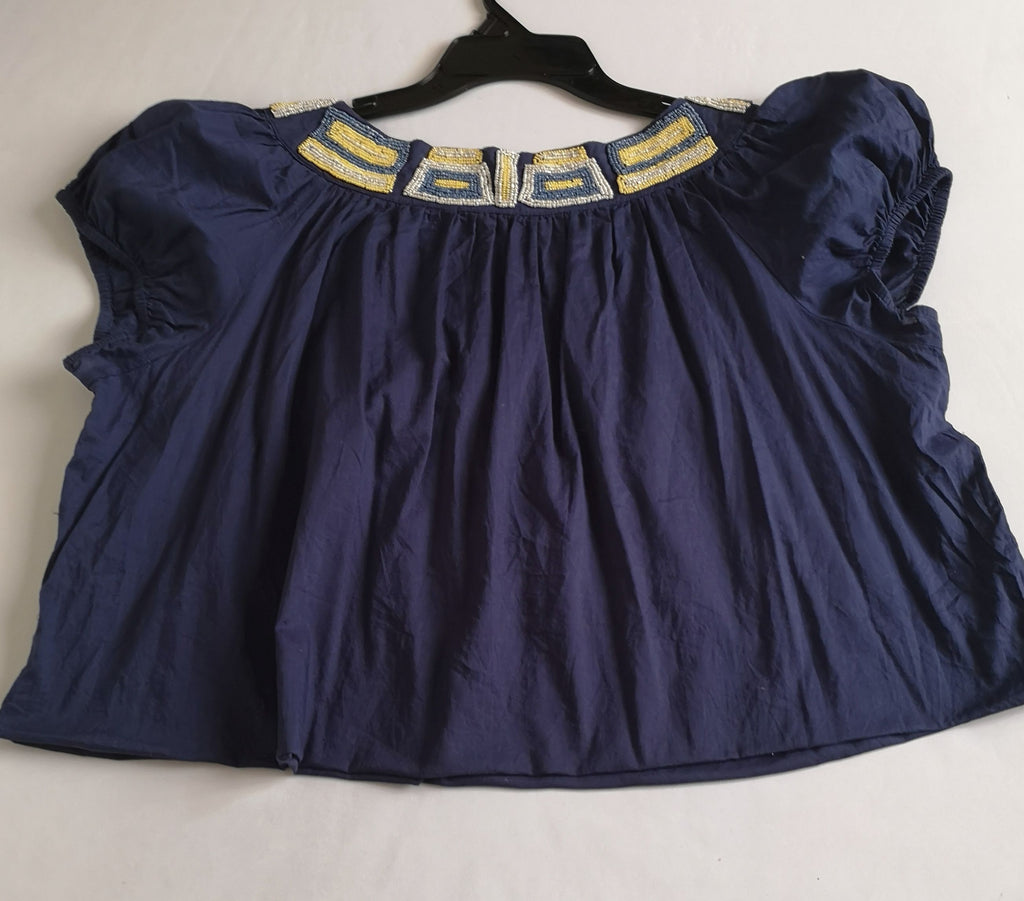 Blusa corta bordada y jeans rasgado